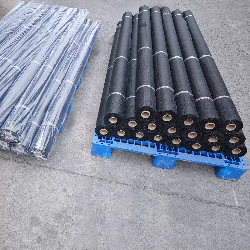 Black screen mesh rolls arranged on a pallet for bulk handling